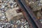 Railway track of iron rails old rusty and cement sleeper against a gravel background