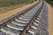 Railway track: rails, sleepers laid through fields, forests for transportation of goods and people.