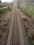 Railway tracks, arrow-straight, single line.