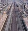 Railway tracks, parallel and lee, with signalling equipment and overhead lines, disappear in the distance