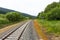 Railway tracks in a rural scene with nice pastel sunset