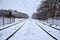 Railway tracks during snowfall in the Netherlands. Train tracks covered with snow in a snow shower near Amersfoort