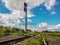 Railway traffic light and locomotive on railroad in distance. Mirage on railway track. Atmospheric landscape.