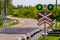 Railway traffic lights with a green signal. Railway and road crossing.