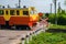 Railway traffic lights with a red signal. Railway crossing with riding train.