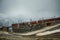 Railway and train in cloudy Gornergrat mountains. Zermatt, Swiss Alps. Adventure in Switzerland.