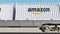 Railway transportation of containers with Amazon.com logo. Editorial 3D rendering