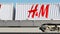 Railway transportation of containers with H&M logo. Editorial 3D rendering