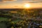 The railway viaduct at Chappel and Wakes Colne in Essex, England the sun a gold ball just above the horizon casting rays light and