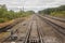 Railway. View from the window of the last train car or from the cab. Russian autumn landscape. Railway rails and sleepers