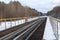 Railway in winter. Rails and sleepers - a road for locomotives and electric locomotive covered with snow.