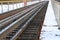 Railway in winter. Rails and sleepers - a road for locomotives and electric locomotive covered with snow.