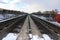 Railway in winter. Rails and sleepers - a road for locomotives and electric locomotive covered with snow.