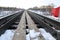 Railway in winter. Rails and sleepers - a road for locomotives and electric locomotive covered with snow.