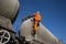 Railway Worker Climbing onto a Tanker Wagon