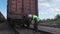 Railway worker inspecting the wagon connection