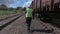 Railway worker with walkie talkie near wagons