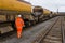 A railway worker walking and inspecting a Network Rail goods train for HS2