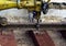 Railway workers bolting track rail. Detail worker with mechanical bolting wrench