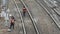 Railway workers on railway repair tracks. Man with huge wrench tightens bolts