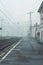 railways station platform at cold cloudy mist or fog day, empty train station in small city