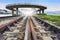 Railways track and bridge cross over with urban scene behind use