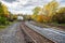 Railways tracks near a train station on a cloudy autumn day