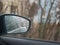 Rain behind the glass of a car. Rain droplets flow down the car glass. Rain behind the windshield of the car inside