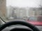 Rain behind the glass of a car. Rain droplets flow down the car glass. Rain behind the windshield of the car inside