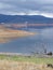 rain clouds form over a half empty reservoir bringing a welcome top-up to the water supply