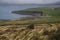 Rain clouds over ireland coast and green landscape.