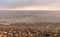 Rain clouds over the sea at sunset. Pebbles on the beach close-up, clouds colored the shades of pink and little waves on