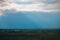 Rain clouds and sunrays. Rural landscape. Horizon