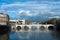 Rain clouds under the Tiber river and Bridge Ponte Sant` Angelo near of Castel Sant Angelo, Roma, Italy, February 2018. Water