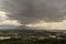 Rain curtaining a view of the mountains.Rain storm over Rice fie