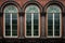 rain droplets on tall, rounded windows of an italianate building