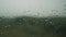 Rain drops appearing on a window glass, rain starting, droplets background