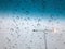 Rain drops on the car sunroof with lamp pole on the street backdrop