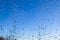 Rain drops running down a window in a close up view