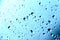 Rain. Drops on the window. Close on the glass. Shower. Wet glass. Blue background.