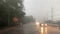 Rain falling on car windshield view. Drive car on road at heavy rain storm, inside a car driving,blurred traffic light background