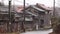 Rain falls in slow motion on old Japanese wooden house in rural village