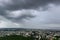 Rain filled monsoon clouds over a town in India