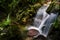 Rain forest waterfall in Wuzhishan, Hainan, China.