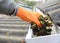 Rain Gutter Cleaning from Leaves in Autumn with hand. Gutter Cleaning. Roof Gutter Cleaning Tips.