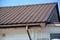 Rain gutter system. Metal roof with plastic roof guttering