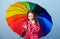 Rain protection. Rainbow. happy small girl with colorful umbrella. autumn fashion. Small girl in raincoat. cheerful