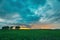 Rain Rainy Clouds Above Countryside Rural Field Landscape With Young Green Wheat Sprouts In Summer Cloudy Sunset Evening