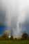 Rain shafts falling through a rainbow