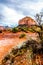 After rain showers, streams and puddles forming at Courthouse Butte, a famous red rock between the Village of Oak Creek and Sedona
